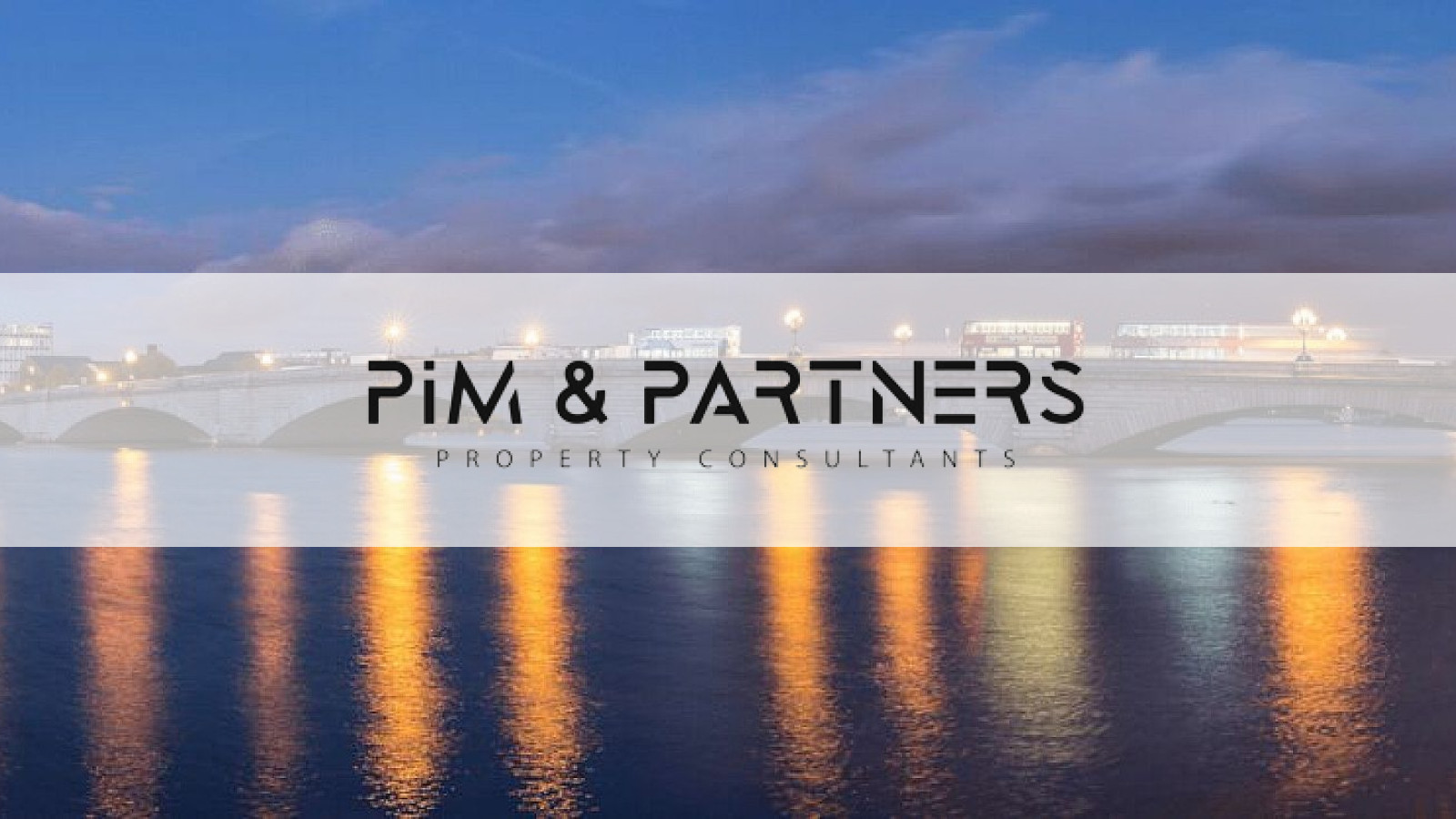 Putney Bridge at dusk, with the Pim & Partners logo
