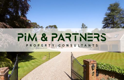 A detached Surrey family home behind gates with a gravel drive, with the PIM & PARTNERS Property Consultants logo