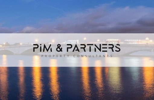 Putney Bridge at dusk, with the Pim & Partners logo