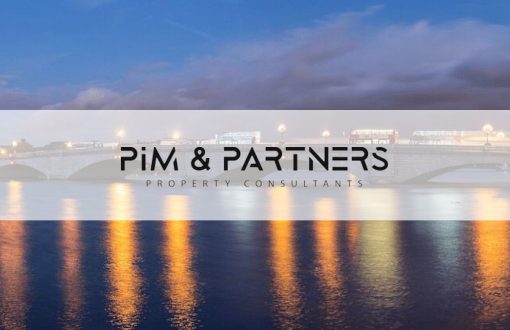 PIM & PARTNERS logo over the Thames at Putney Bridge at dusk